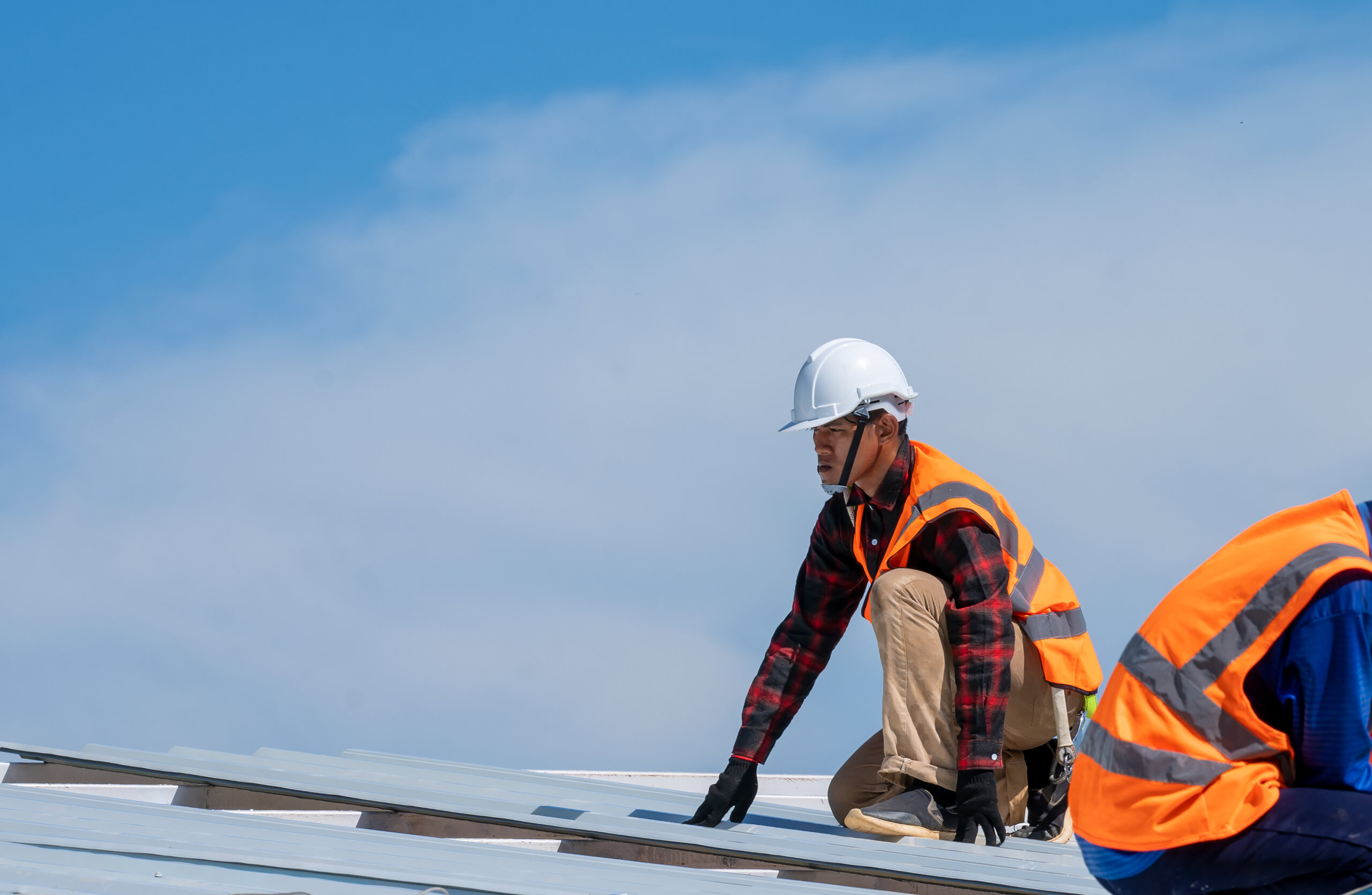 Roofer worker in protective uniform wear installing metal roof o